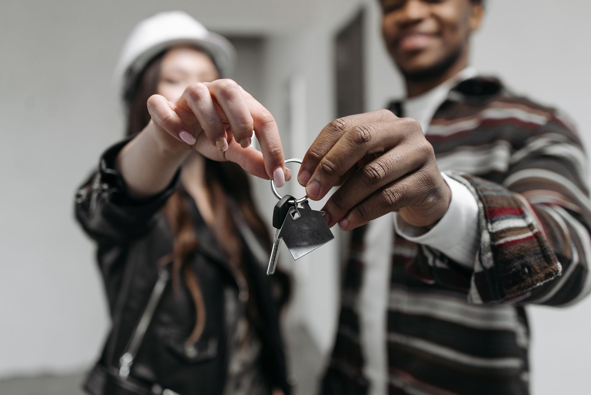 A couple holding the keys to a new home, representative of first-time Dholera buyers