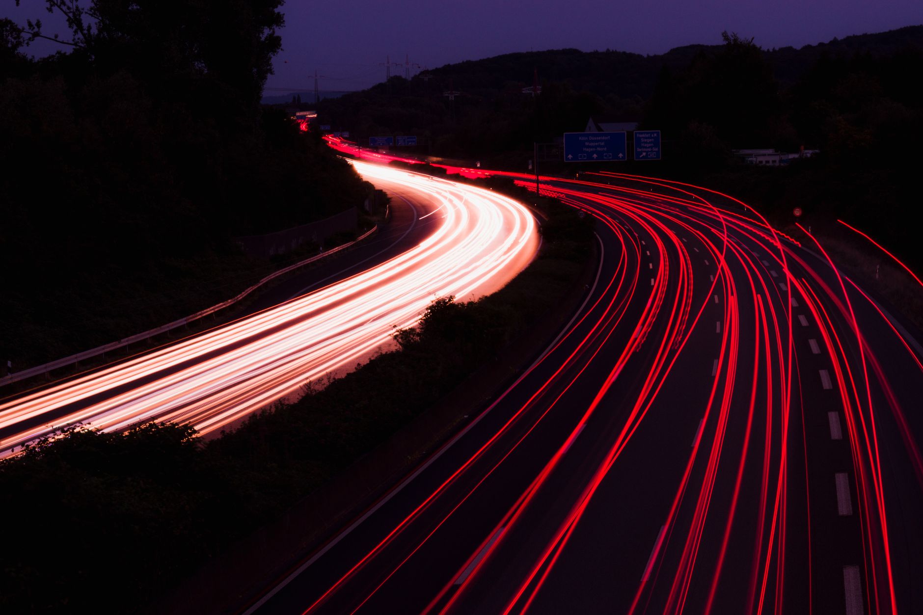 Highway at night with light trails, representative of Dholera connectivity upgrades